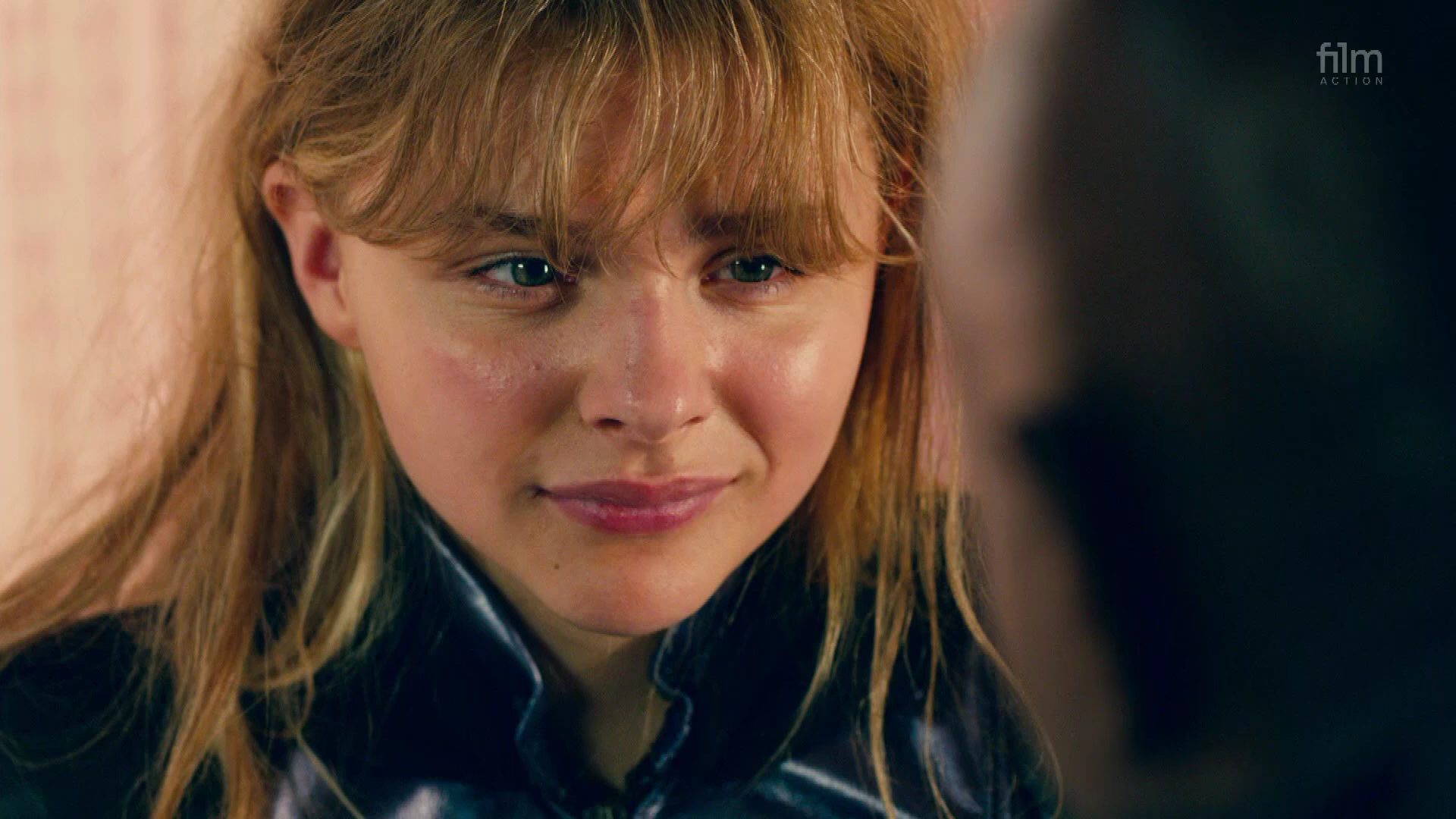 Close up of Chloë Grace Moretz as Hit Girl in Kick Ass 2, talking to her guardian Marcus