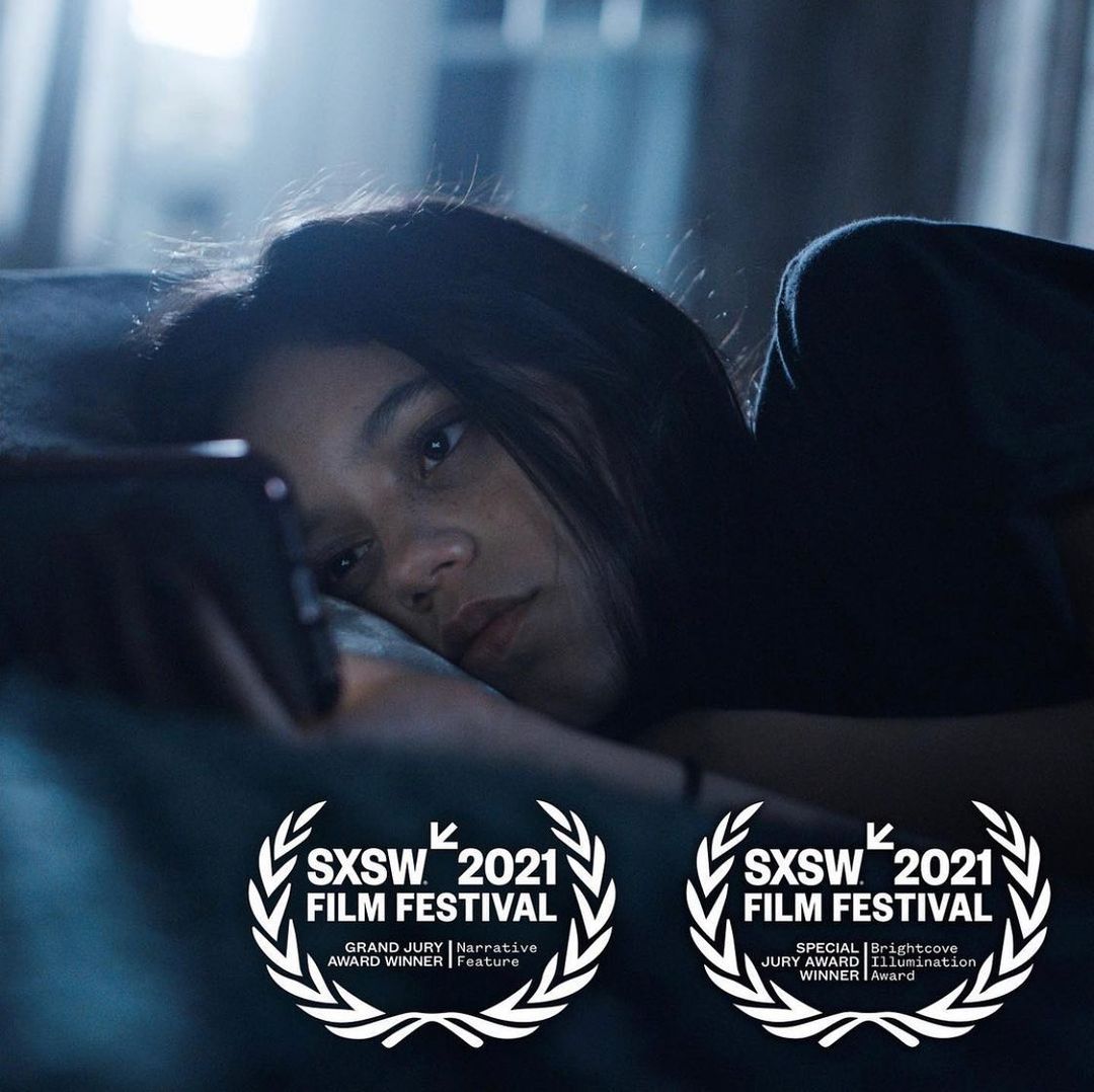 Jenna as Vada in a still from the film, lying on her bed reading her phone. The image has festival laurels printed on it, for the Grand Jury Award winner and the Brightcove Illumination Award for director Megan Park