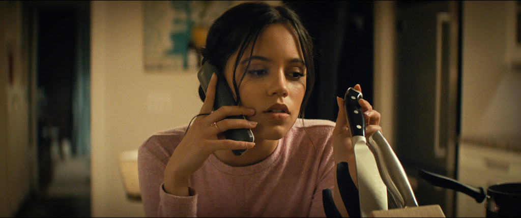 Jenna Ortega in Scream, playing with a kitchen knife.